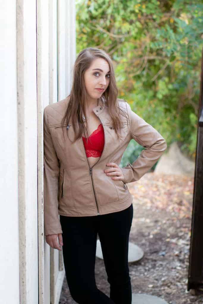 Girl pairing a red bralette with a taupe jacket