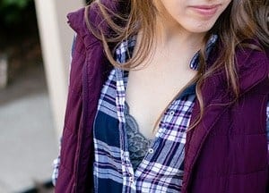 Woman wearing bralette under plaid shirt