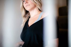 Woman wearing a halter bralette inside a black shirt