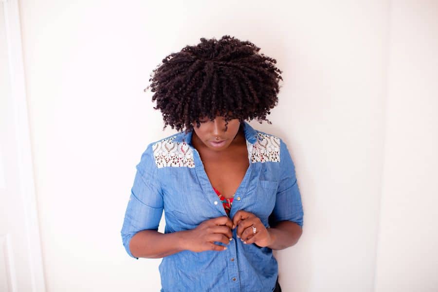 Woman closing the buttons of her top