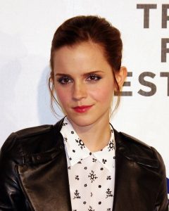 Emma Watson wears a black leather jacket and a floral blouse being photographed at Tribeca Film Festival