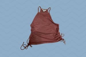 A brown halter top with adjustable string on both sides placed on a blue background