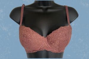 An old rose push-up bra with underwire and adjustable straps is placed on a black mannequin