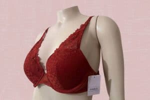 A red push-up underwired bra with a lace floral design placed on a white mannequin