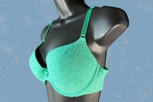 Green push-up bra with underwire and adjustable straps placed on a black mannequin