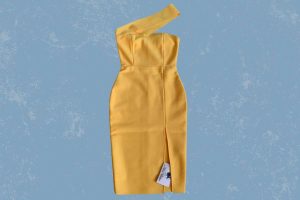 A yellow one shoulder bodycon dress with a slit on the left side