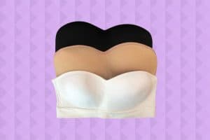 Three strapless bras with different colors pile up vertically on a purple background