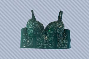 A green bustier bra with sequins and broad bands placed on a gray background