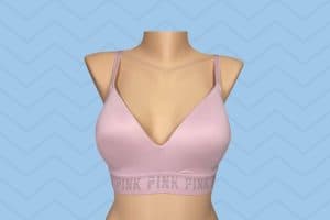 Light pink regular bra with broad bands placed on a brown mannequin