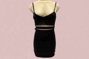 A black cut-out spaghetti strap bodycon dress placed on a cream mannequin