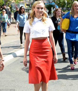 Diane Kruger wearing a white crop top blouse and red leather skirt