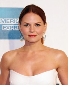 Jennifer Morrison wearing a white tube top and dangling earrings at a movie event