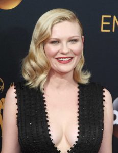 Kirsten Dunst wearing a sleeveless sheer black beaded v-neck dress at the Emmys