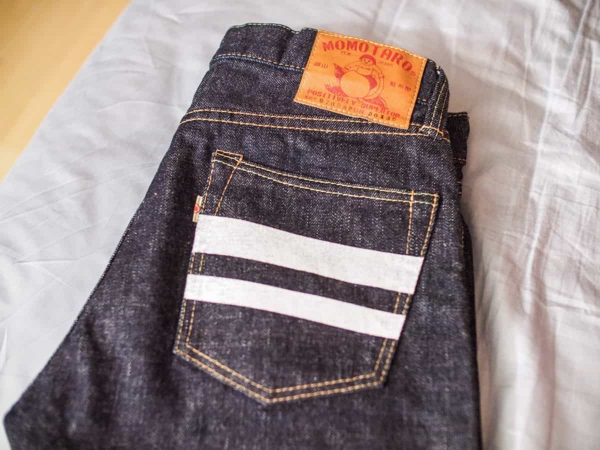 A brand new folded jeans on the bed