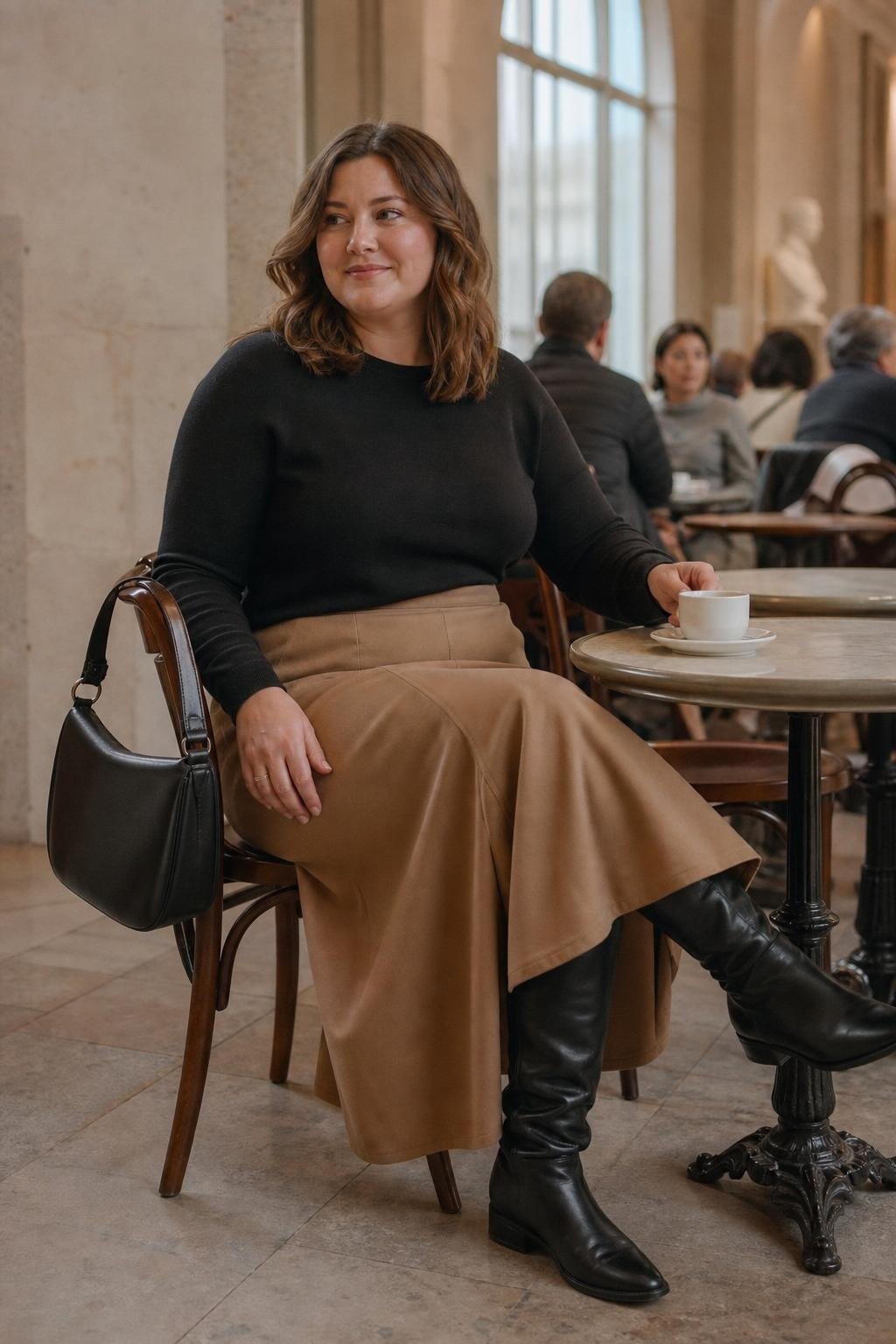 Black crewneck sweater, camel A-line midi skirt, black knee boots, leather shoulder bag, museum cafe afternoon (option 2)