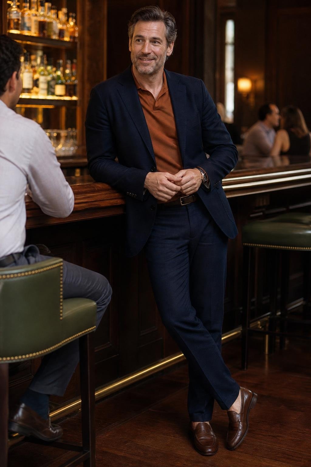 Copper polo, deep navy unstructured blazer and trousers, brown loafers, sophisticated hotel bar meeting (option 1)