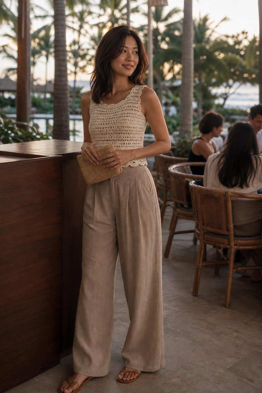 Ivory crochet top, loose taupe trousers, flat sandals, woven clutch, relaxed resort restaurant evening (option 2)