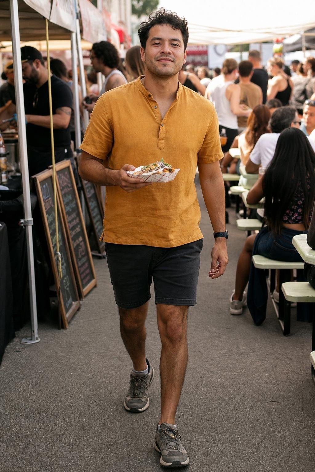 Marigold popover shirt, faded black shorts, gray trail sneakers, busy outdoor food festival (option 1)