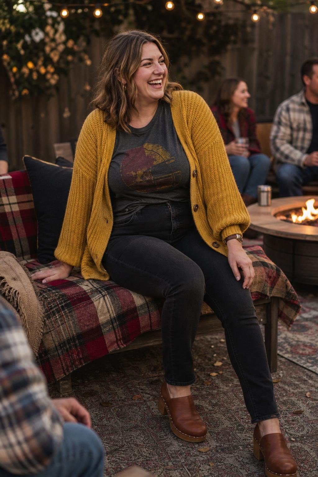 Mustard chunky cardigan, faded graphic team tee, black jeans, brown clogs, cozy backyard watch party (option 2)