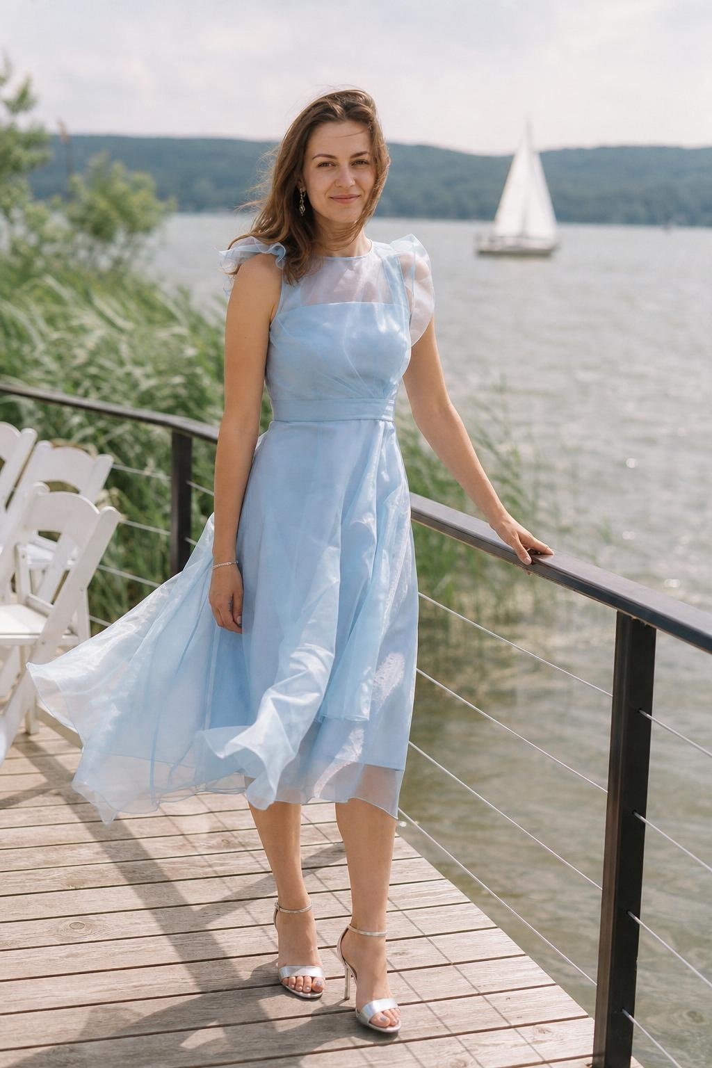 Sky blue organza midi dress with silver sandals beside a lakeside dock (option 1)