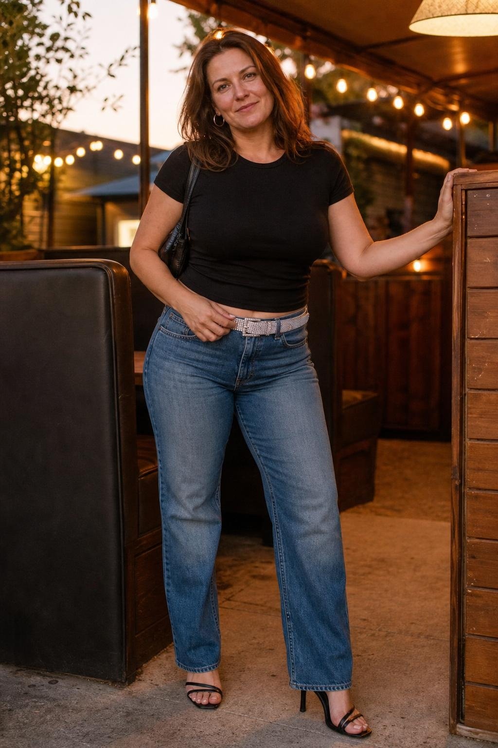 Straight-leg jeans, black fitted tee, rhinestone belt, heeled sandals, casual bar booth sparkle (option 1)