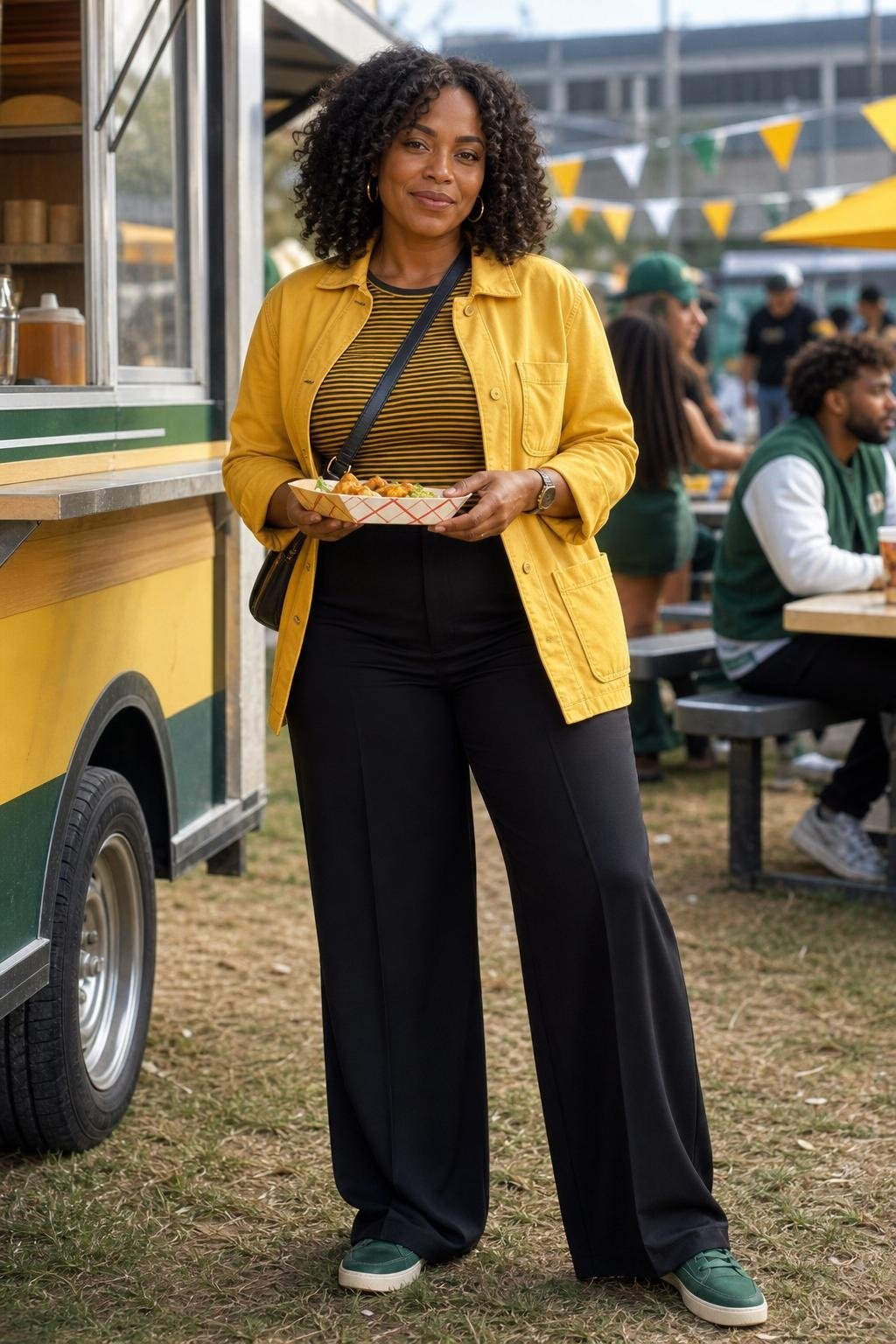 Yellow chore jacket, black wide-leg pants, striped tee, green sneakers, daytime stadium food truck area (option 1)