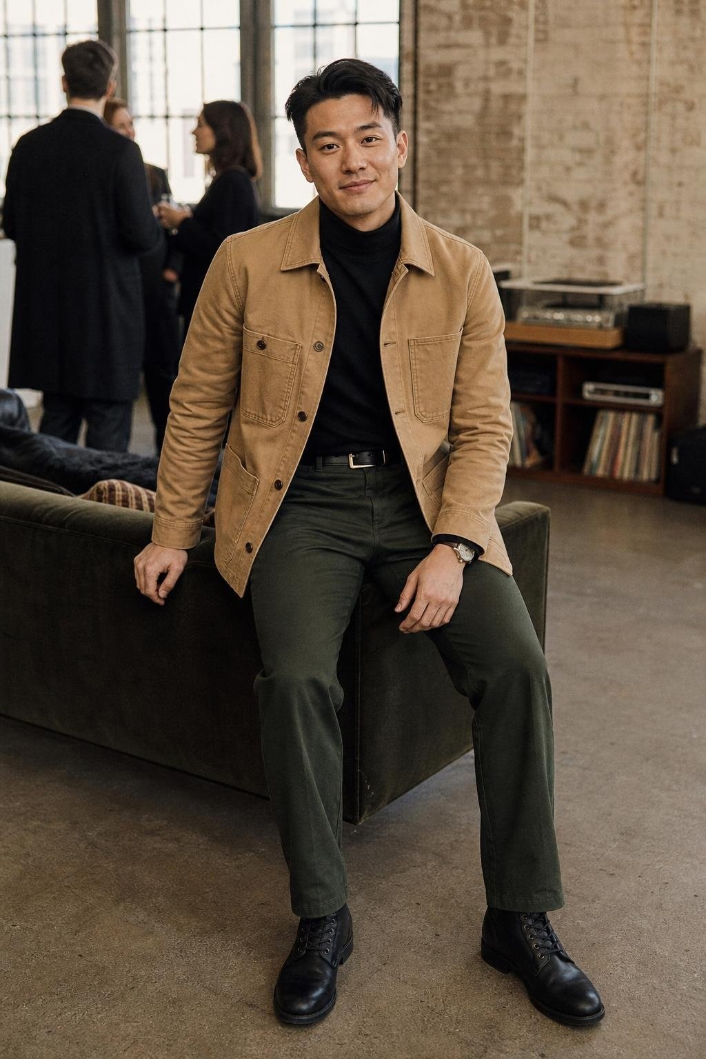 Tan canvas chore coat, black turtleneck, dark green trousers, black leather boots, industrial loft gathering (option 1)